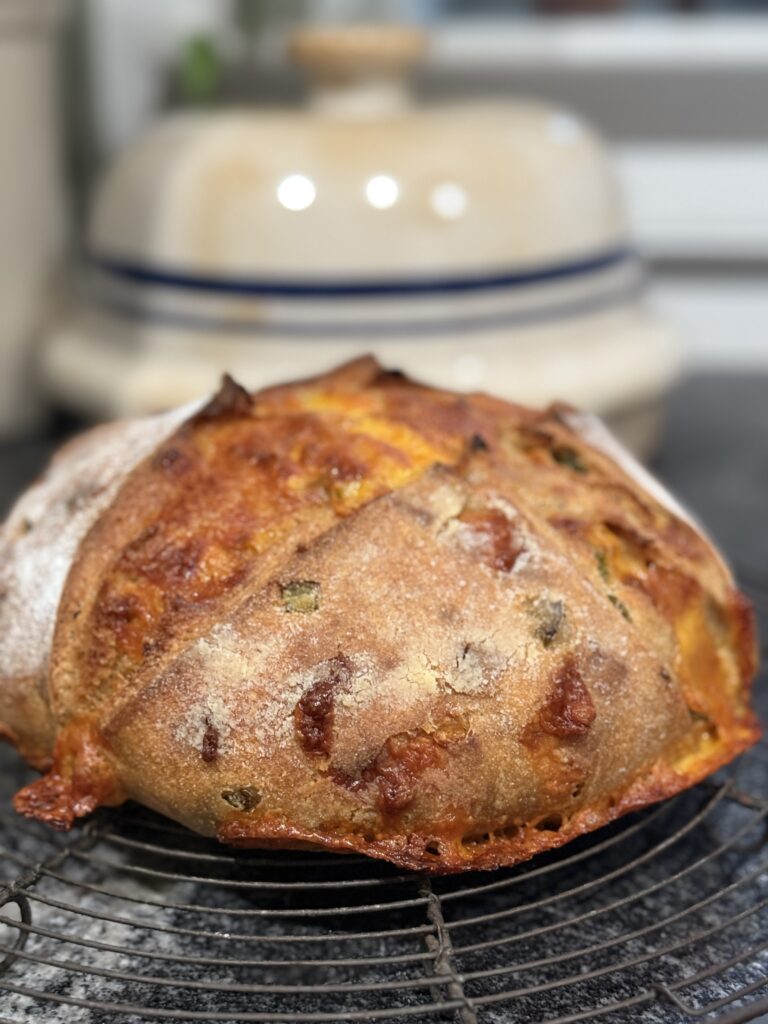 Jalapeno cheddar sourdough loaf with pottery bread baker from Lehman’s